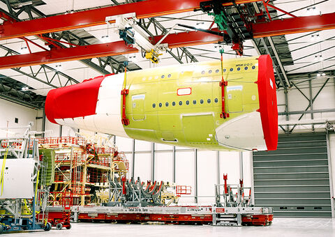 Aircraft part lifted by overhead crane