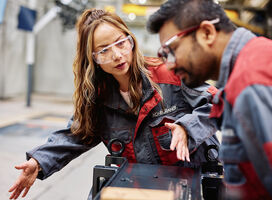 Woman and man working on Konecranes factory floor.  