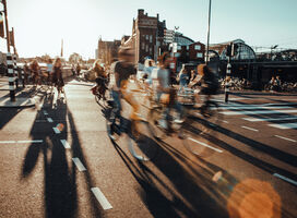 Bikers in a city crossing road.